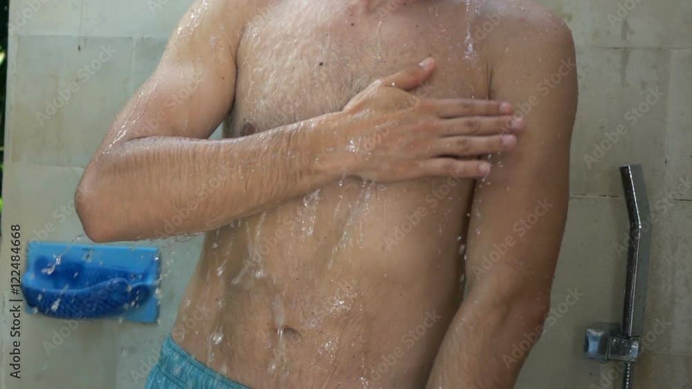 Young man washing body under shower in garden, super slow motion 240fps
Young man washing body under shower in garden, super slow motion 240fps