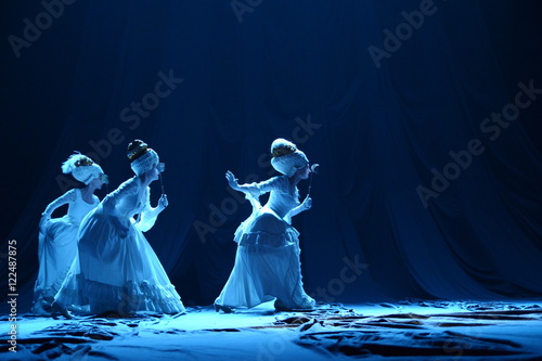 Three girls in vintage dresses actress on stage photo