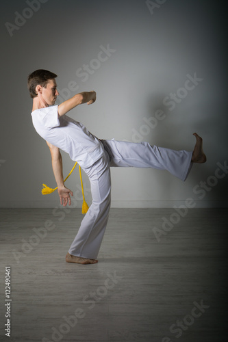 Man in sportswear performing a kick.