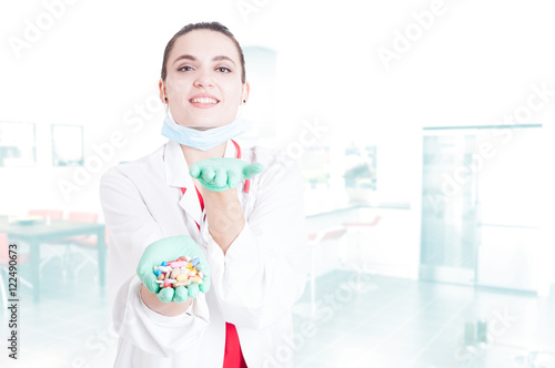 Cheerful pretty medic offering you capsules