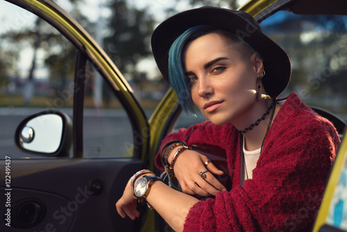 Closeup face portrait of folk singer with guitar in car outdoors photo