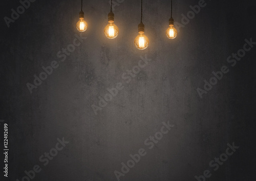 tungsten light bulb on empty blackboard with copy space for inspiration or idea under light bulb