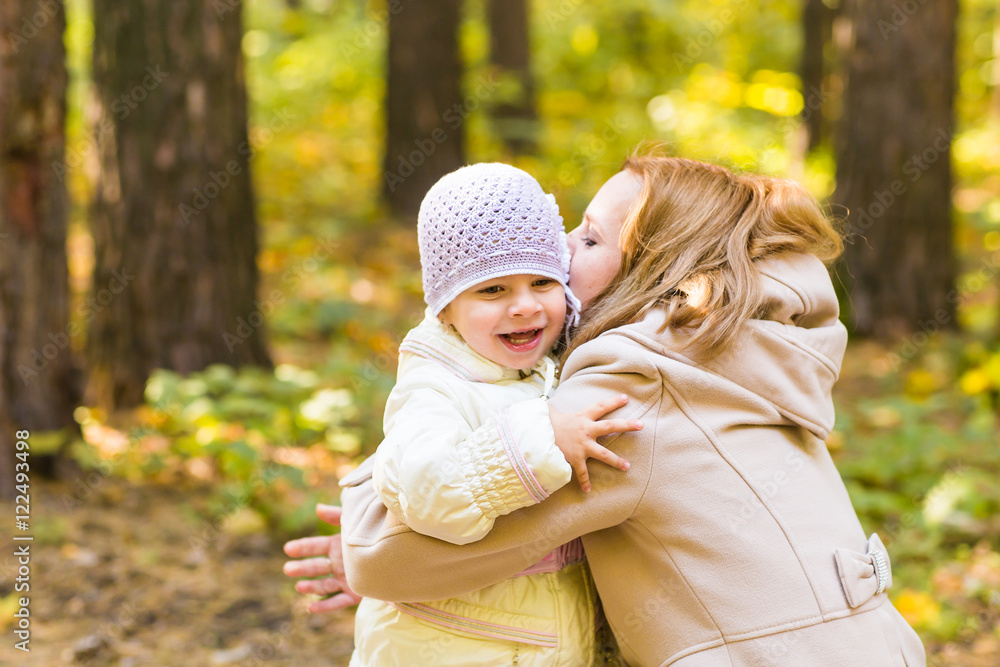 closeup of mother and daughter in the autumn park closeup of mother and daughter in the autumn park