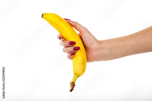The girl tightly holding a banana on a white background.