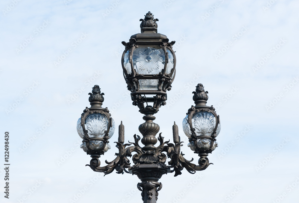 Parisian lamppost closeup against clear sky