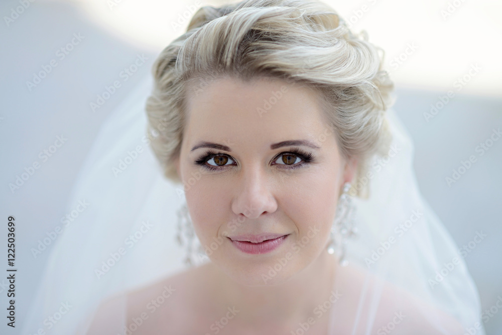 Beauty bride in bridal gown with lace veil on the nature. Beautiful model girl in a white wedding dress. Female portrait in the park. Woman with hairstyle. Cute lady outdoors Beauty bride in bridal gown with lace veil on the nature. Beautiful model girl in a white wedding dress. Female portrait in the park. Woman with hairstyle. Cute lady outdoors
