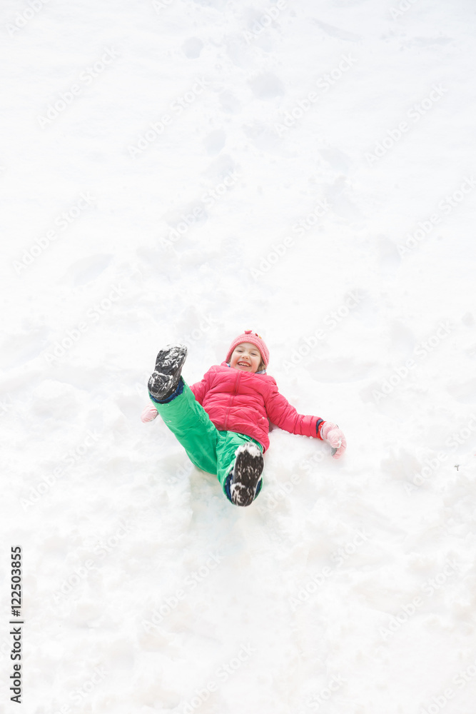 Playful girl with braids playing in the first snow Playful girl with braids playing in the first snow