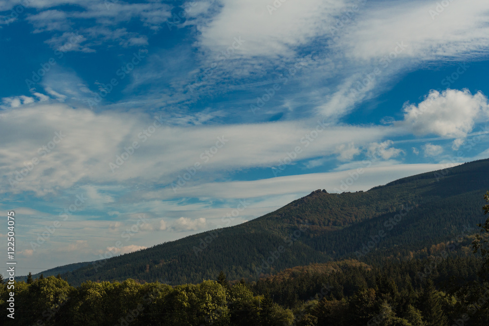 Summer landscape in mountains and the dark blue sky with clouds