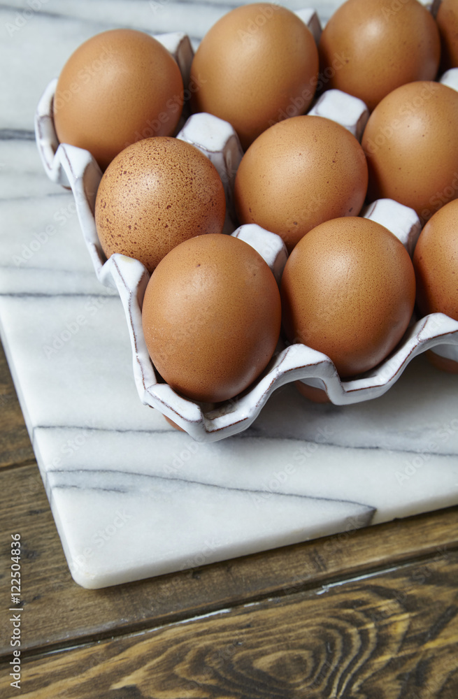 Chicken eggs on a wooden table top background forming a page border Chicken eggs on a wooden table top background forming a page border