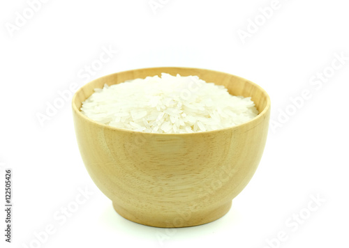Rice in woodbowl on white background.
