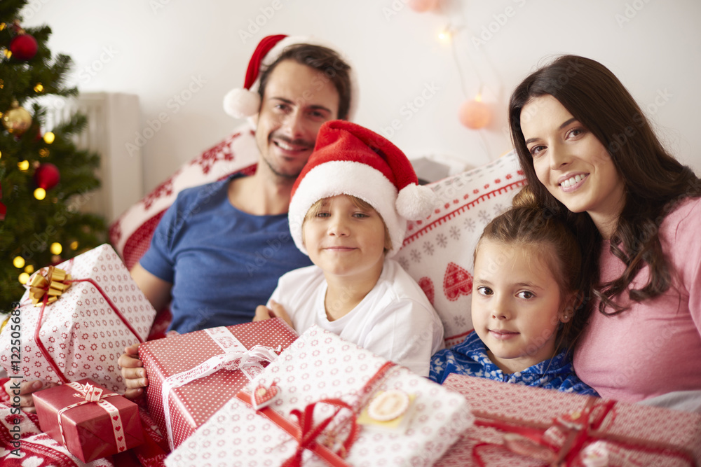 Family spending Christmas morning in bed Family spending Christmas morning in bed