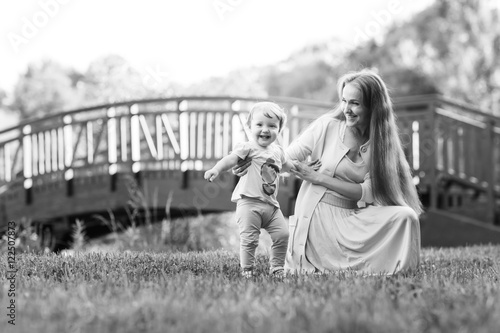 Young mother with daughter in park , black and -white photo