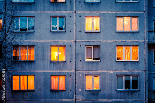 Wall with Iluminated windows. Detail of soviet era block apartment building