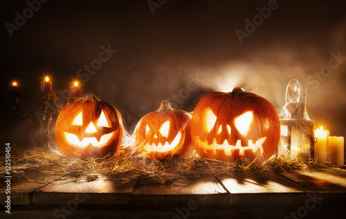 Scary halloween pumpkins on wooden planks