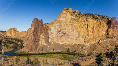 The river is flowing among the rocks. Colorful Canyon. Amazing landscape of yellow sharp cliffs. Smith Rock state park, Oregon