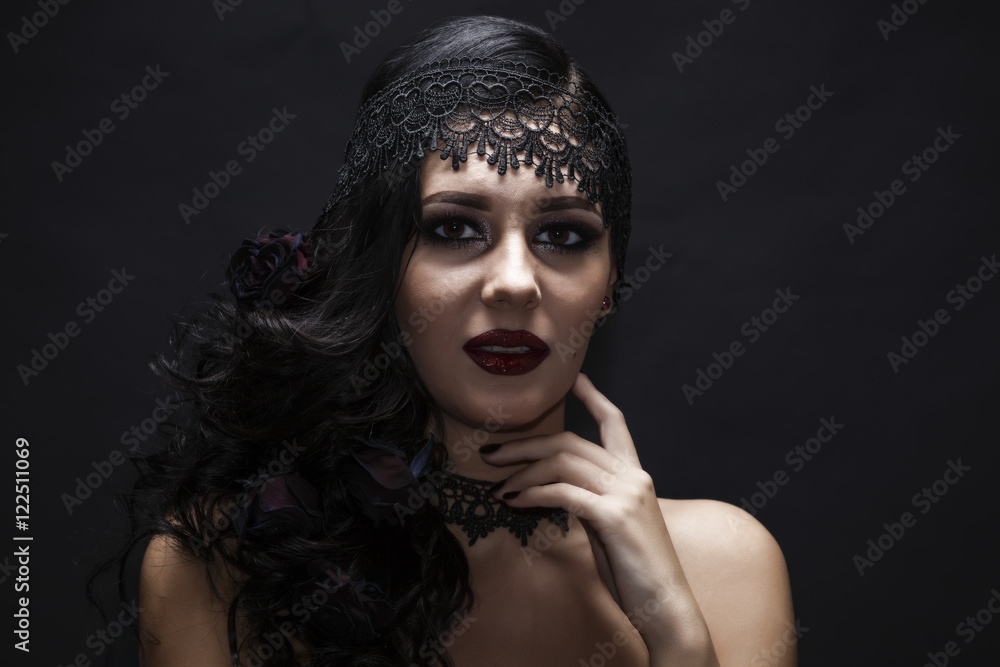 Portrait of a gorgeous brunette with a hat over black background Portrait of a gorgeous brunette with a hat over black background