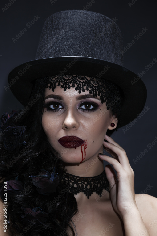Portrait of a gorgeous brunette with a hat over black background Portrait of a gorgeous brunette with a hat over black background