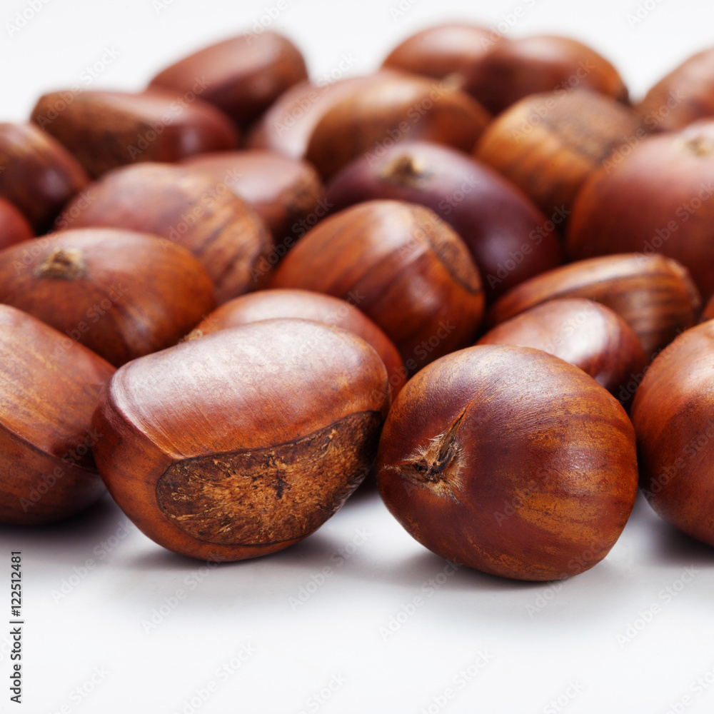 Group of grilled chestnuts. Isolate on white background. Autumn background. Group of grilled chestnuts. Isolate on white background. Autumn background.