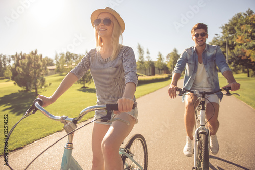 Couple cycling in park