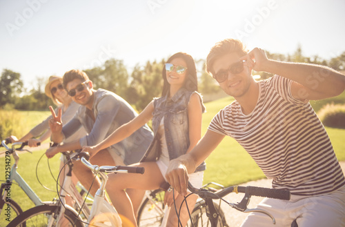 Friends cycling in park
