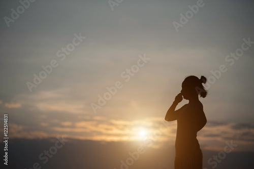 silhouette woman sad in the sunset
