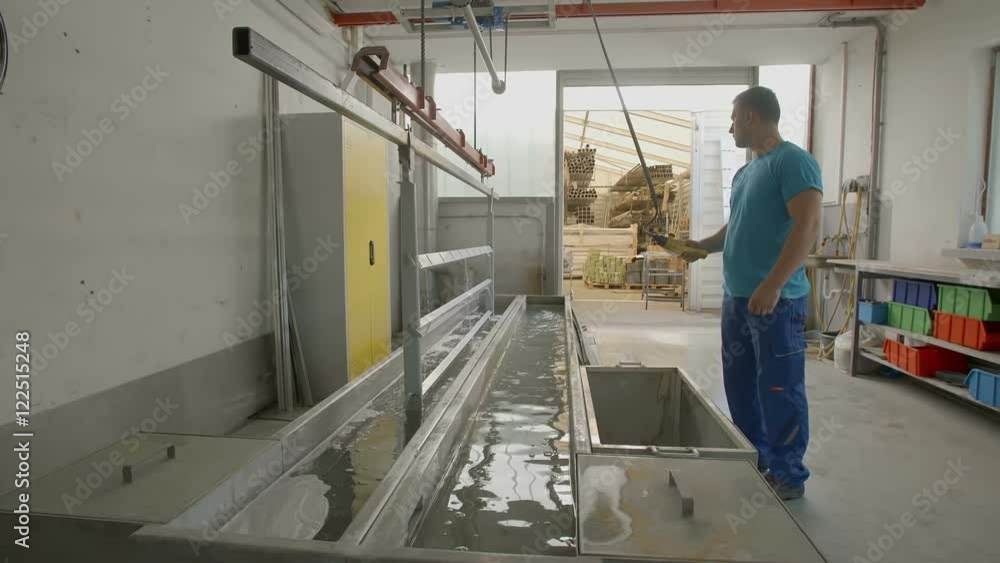A worker is lifting up items from the water after they have been washed and are now ready to go to the body shop. Wide-angle shot.
A worker is lifting up items from the water after they have been washed and are now ready to go to the body shop. Wide-angle shot.