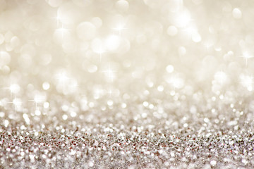 Silver white glittering Christmas lights. Festive abstract glitter bokeh background