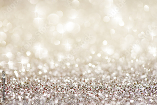 Silver white glittering Christmas lights. Festive abstract glitter bokeh background