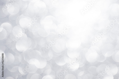 Silver white glittering Christmas lights. Festive abstract glitter bokeh background