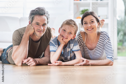 At home, a cheerful are lying on the wooden floor