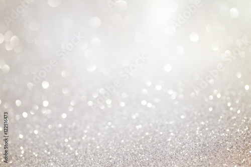 Silver glittering christmas lights. Blurred abstract holiday background