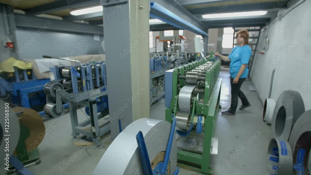 A woman who is working behind a production line in the factory is pushing a button on the screen and then she takes a step back. Wide-angle shot.
A woman who is working behind a production line in the factory is pushing a button on the screen and then she takes a step back. Wide-angle shot.