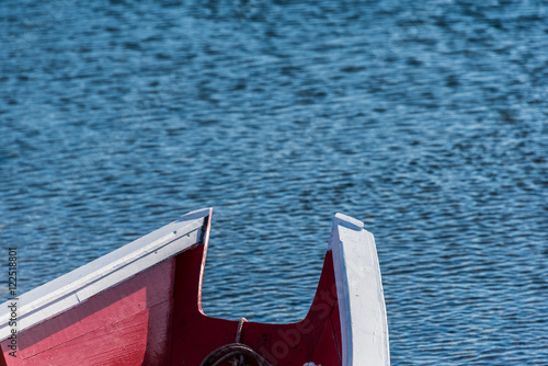 close up of aft section of small red fishing boat photo