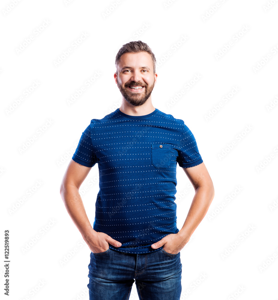 Fototapeta premium Hipster man in blue t-shirt, studio shot, isolated