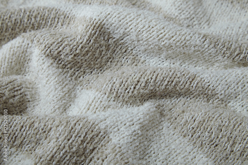 A full page of beige and white stripe knitted sweater background texture