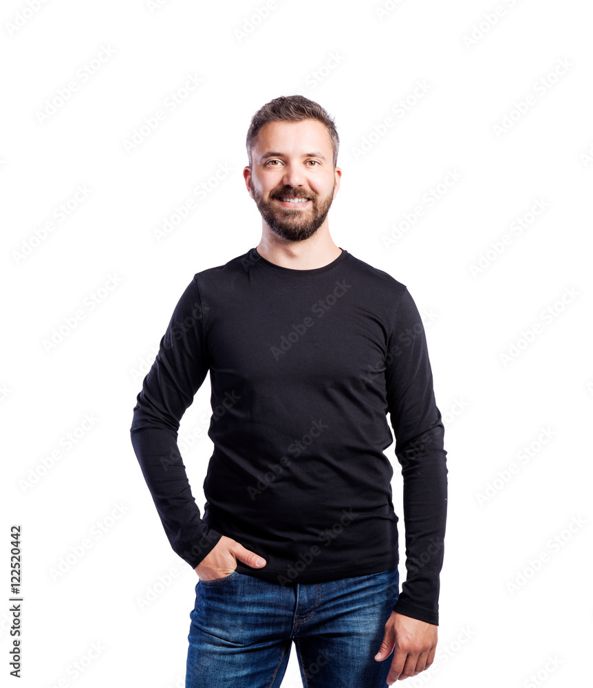 Hipster man in black long-sleeved t-shirt, studio shot, isolated Hipster man in black long-sleeved t-shirt, studio shot, isolated