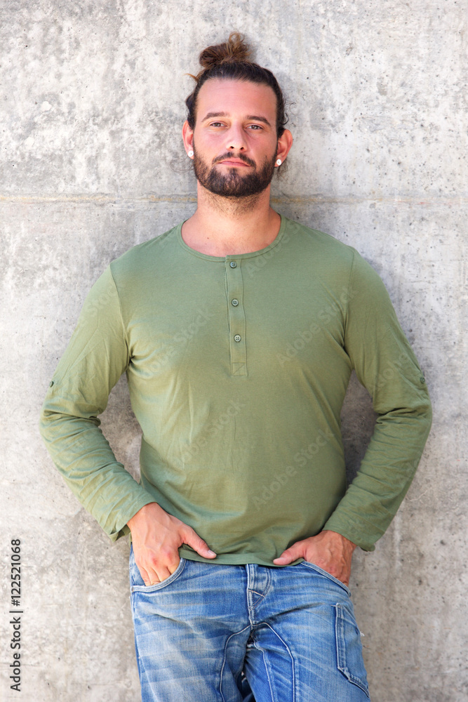 Serious man standing with hands in pockets Serious man standing with hands in pockets