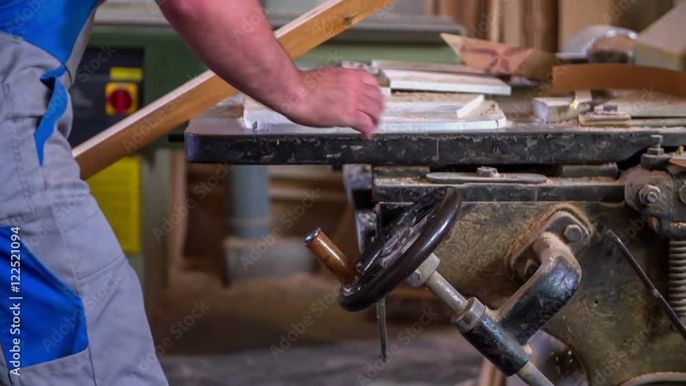 A man is taking a piece of wood and he is slowly putting it inside the machine. He is trying to make a wooden car. Close-up shot.
A man is taking a piece of wood and he is slowly putting it inside the machine. He is trying to make a wooden car. Close-up shot.