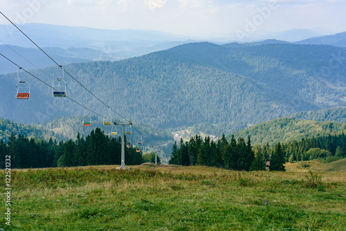 Lift in the Carpathians with mountains and fir-trees in the background. Summer time