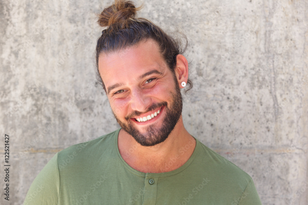 Smiling man with ponytail and beard