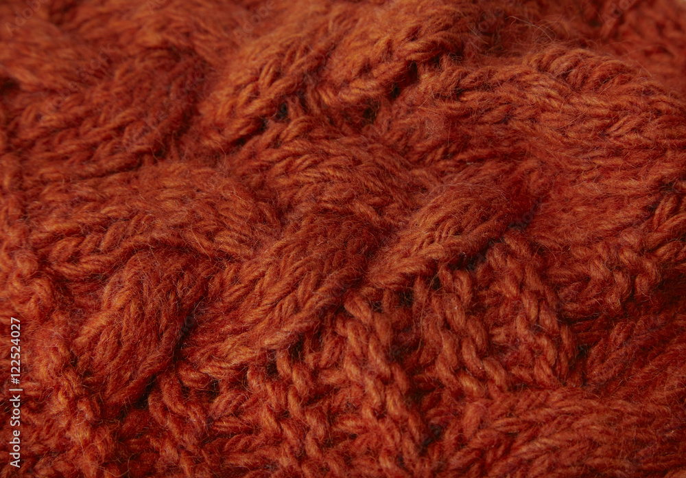 A full page of burnt orange chunky knitted background texture A full page of burnt orange chunky knitted background texture