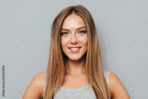Close up portrait of casual smiling girl looking at camera