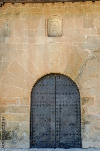 door of semicircular arch of a convent of the medieval town of Albarracin in Teruel, Aragon, Spain