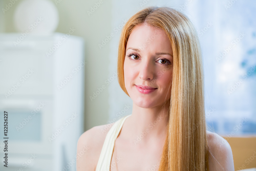 Young beautiful woman with long straightened shiny hair
