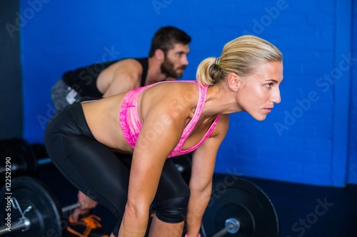 Young athlete lifting barbell 