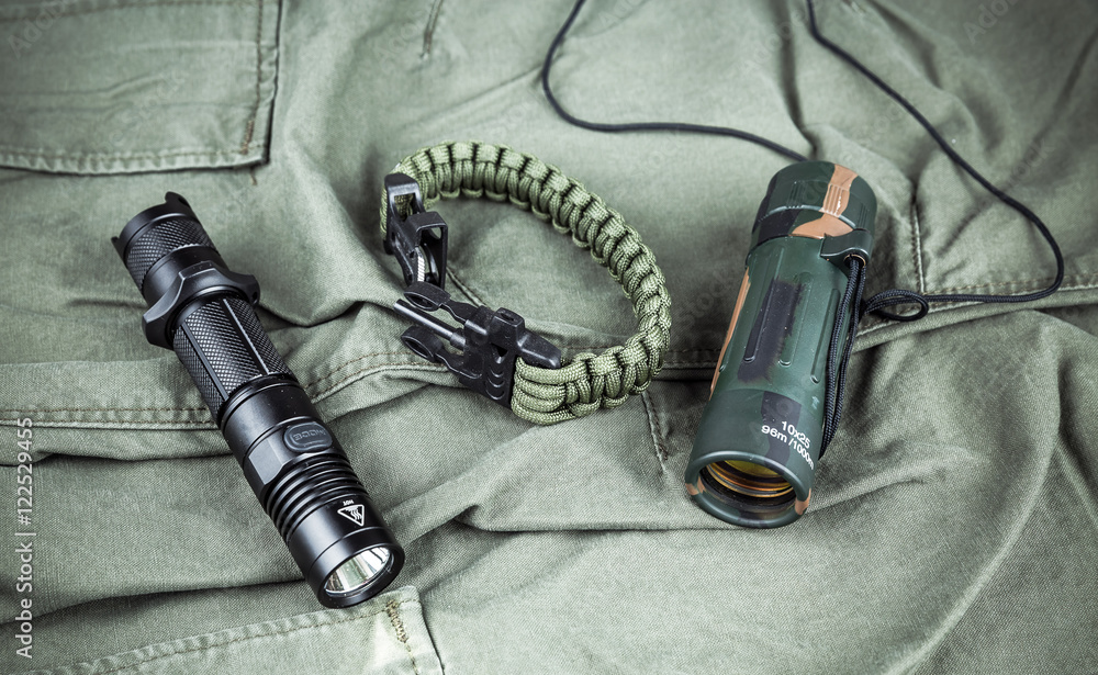 Military paracord bracelet, tactical torch and spy-glass Stock Photo
