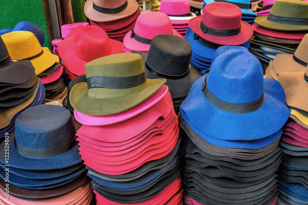Felt hats of all sizes for sale in stand of outdoor flea market, Chinatown district, Bangkok, Thailand