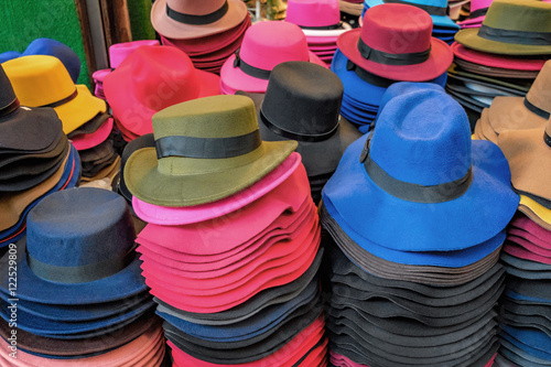 Felt hats of all sizes for sale in stand of outdoor flea market, Chinatown district, Bangkok, Thailand