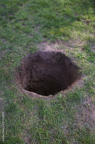 Deep dirt hole in ground