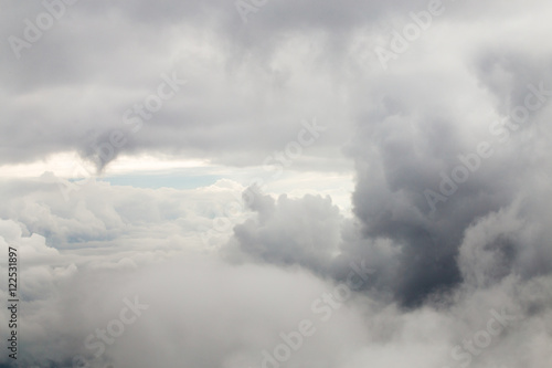 Closeup large gray clouds in the sky the view from the airplane window. © Kotkoa